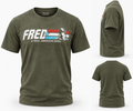 Olive green short-sleeve t-shirt shown from multiple angles, featuring a front graphic with the text 'FRED' and 'A REAL AMERICAN HERO' over a stylized American flag and helmet illustration.